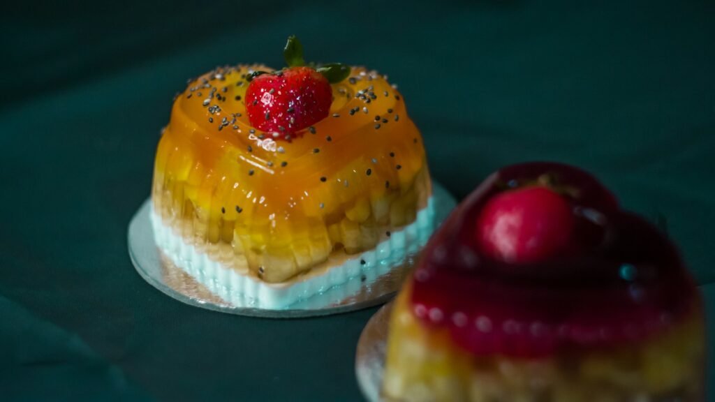 Two jelly desserts topped with fruit