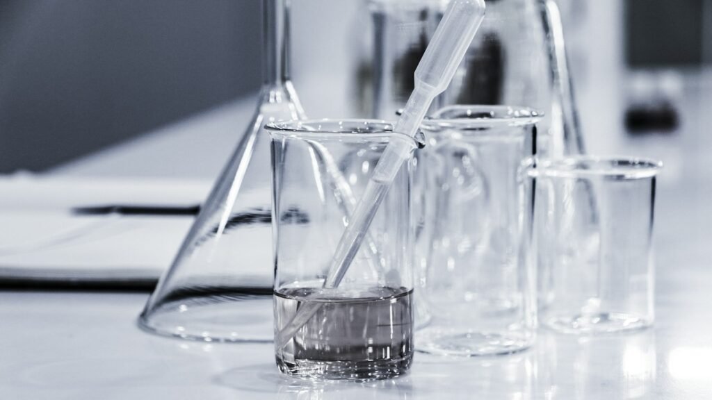 Three clear laboratory beakers on a tabletop