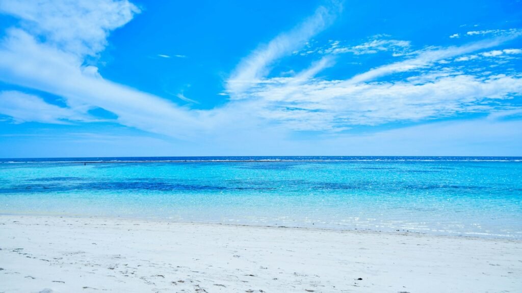 White sandy beach with shallow blue water