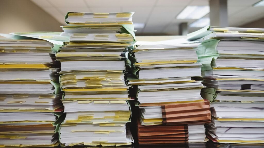 Stacks of paper documents and file folders