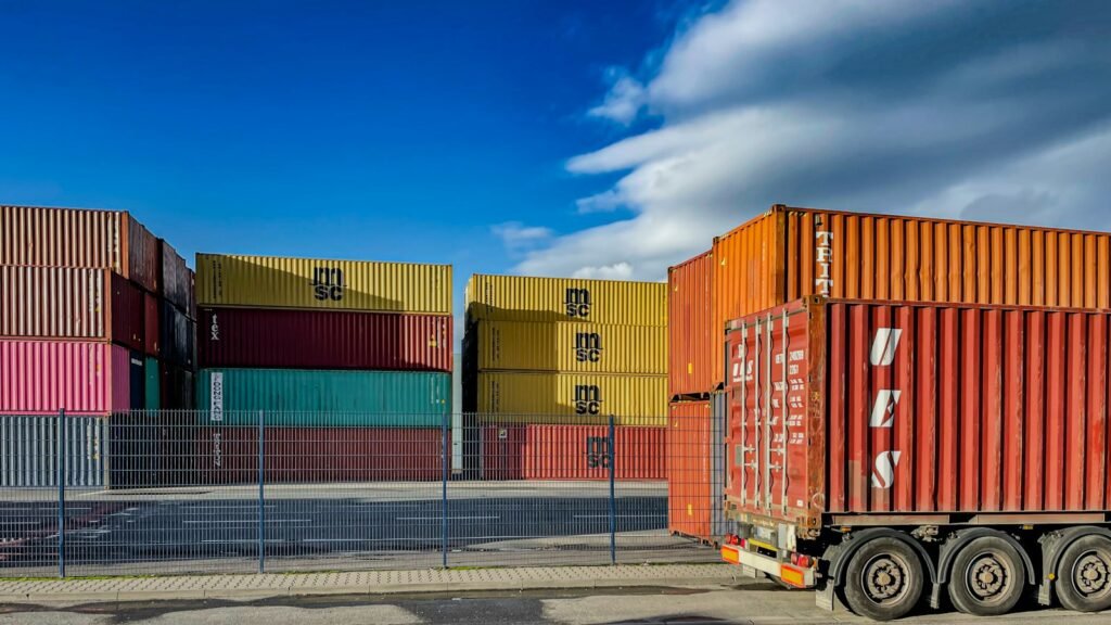 Truck parked in front of shipping containers